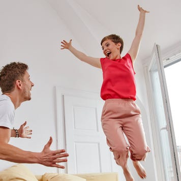 A couple jumps up and down