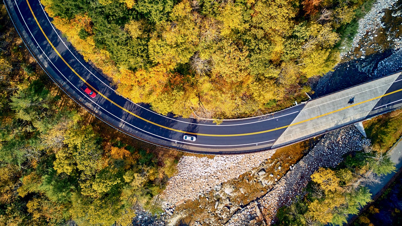 aerial view of cars driving along a winding road