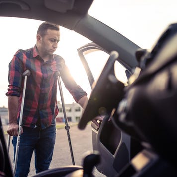 Man using crutches is about to take the car