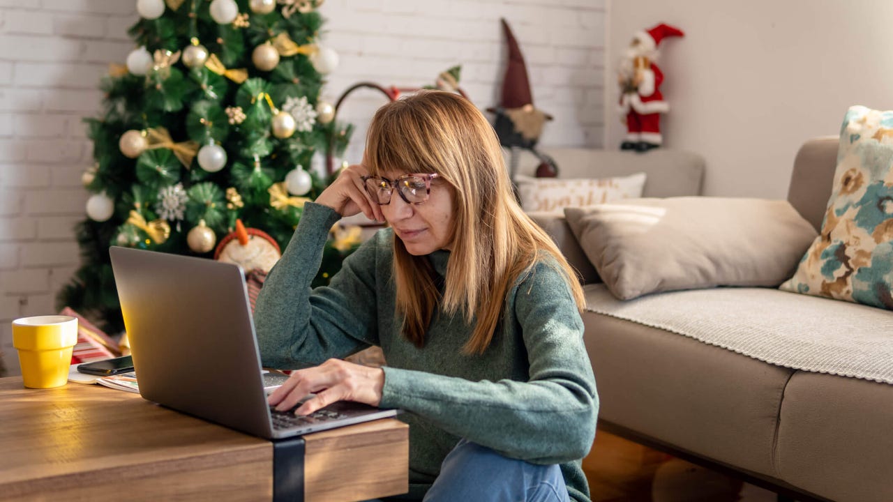 Mature woman shopping online at Christmas