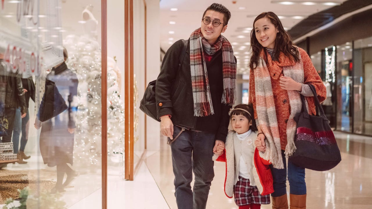 Happy family strolling in shopping mall