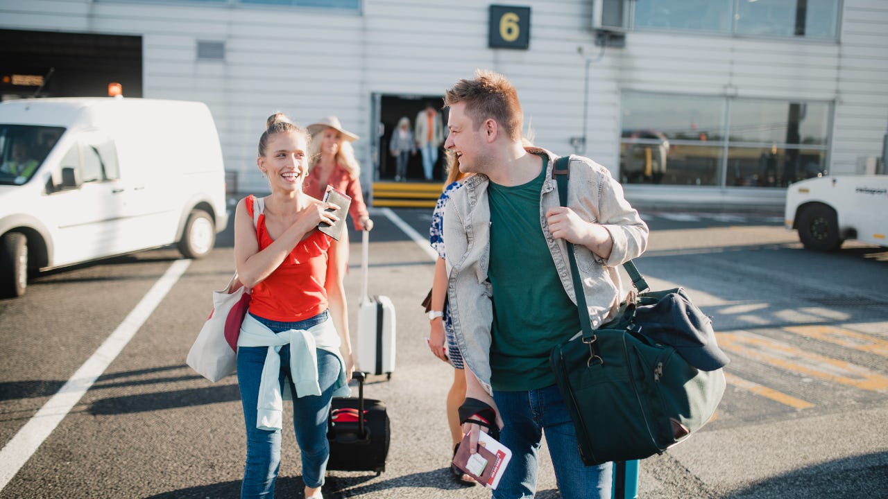 Young couple boarding their plane at the airport.