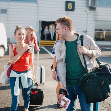 Young couple boarding their plane at the airport.