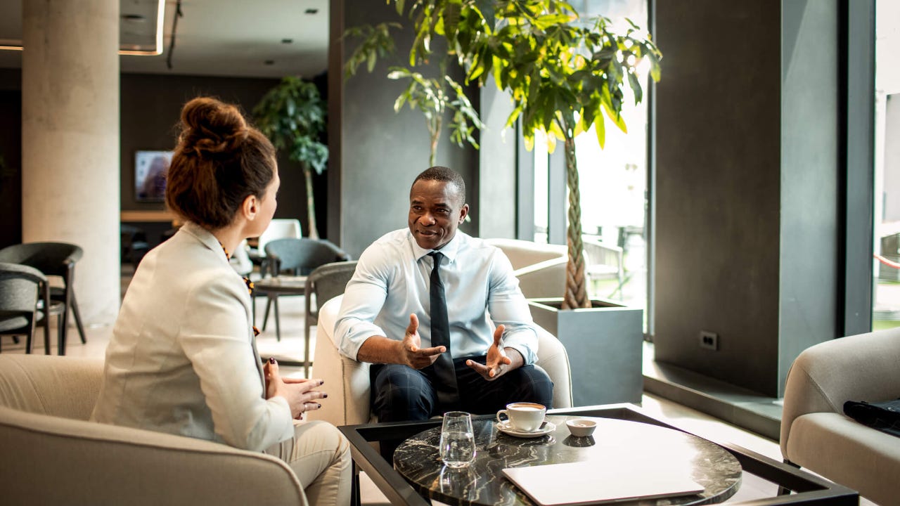 Business colleagues having coffee in a hotel lobby