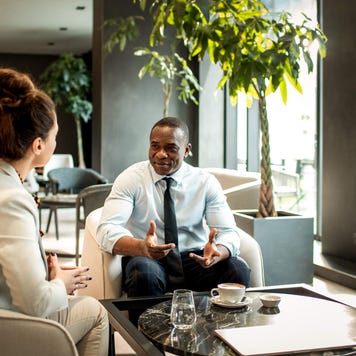 Business colleagues having coffee in a hotel lobby