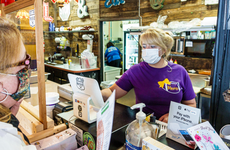 Cashier and customer wear face masks at a store during the pandemic