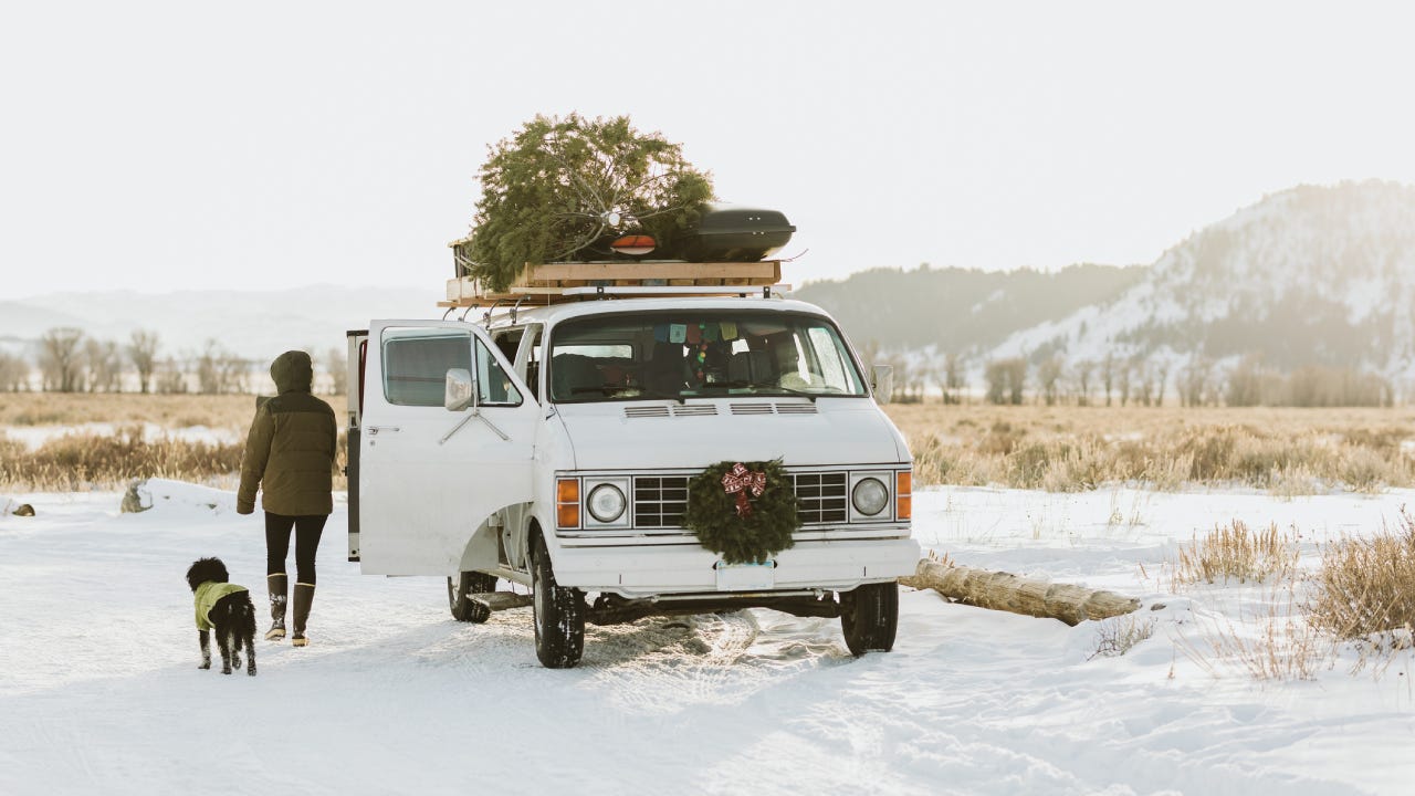 Vintage white van parked with christmas tree and wreath
