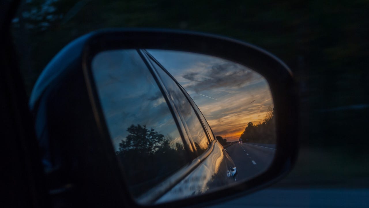 Reflection Of Car In The Sunset On Side-View Mirror