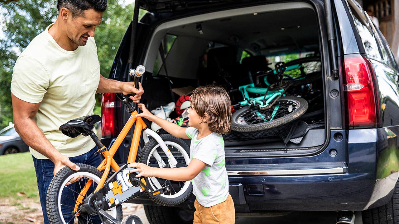 Father and son loading bicycles into car