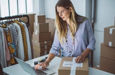 Small business owner packing packages to ship