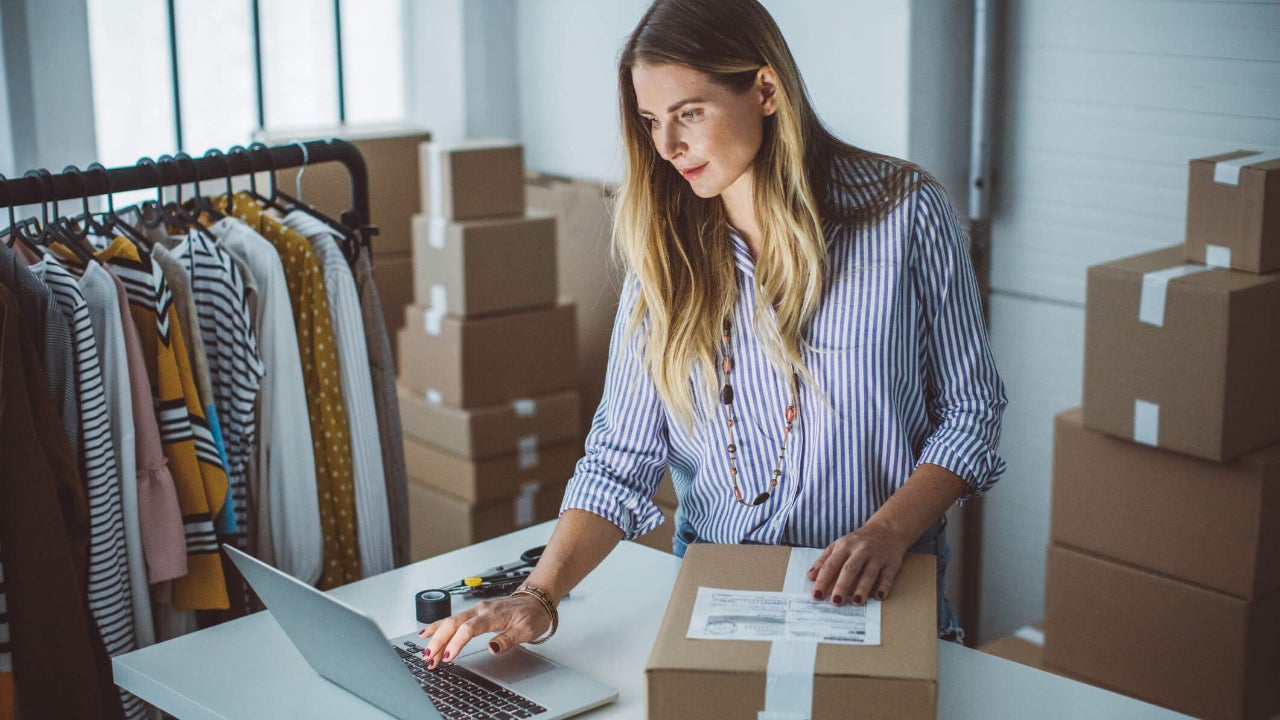 Small business owner packing packages to ship