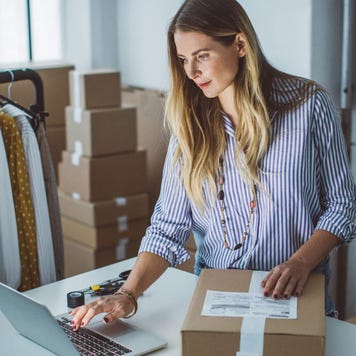 Small business owner packing packages to ship