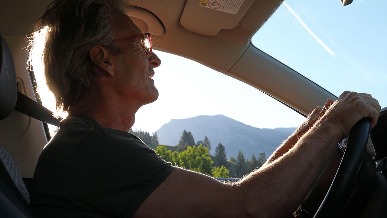 man driving in the mountains