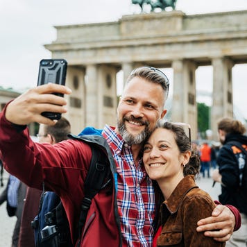 A Mature Couple Take A Selfie Together In Front Of Brandenburg Gate in Berlin