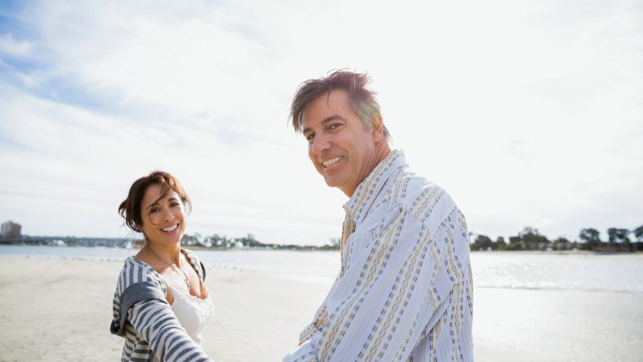 Portrait of smiling mature couple on beach vacation