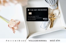 Key Rewards Visa Credit Card resting on a platter next to flowers and a key ring