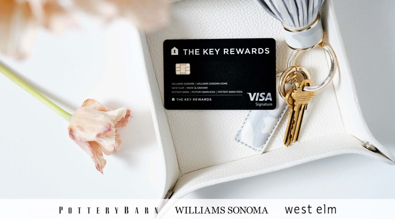 Key Rewards Visa Credit Card resting on a platter next to flowers and a key ring