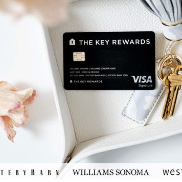 Key Rewards Visa Credit Card resting on a platter next to flowers and a key ring