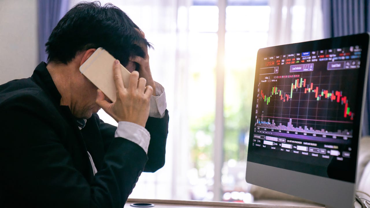 A trader watches a falling stock chart