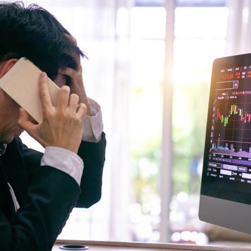 A trader watches a falling stock chart