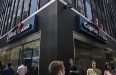 Pedestrians pass in front of a Capital One Financial Corp. bank branch in New York, U.S., on Wednesday, July 19, 2018. Capital One Financial Corp.