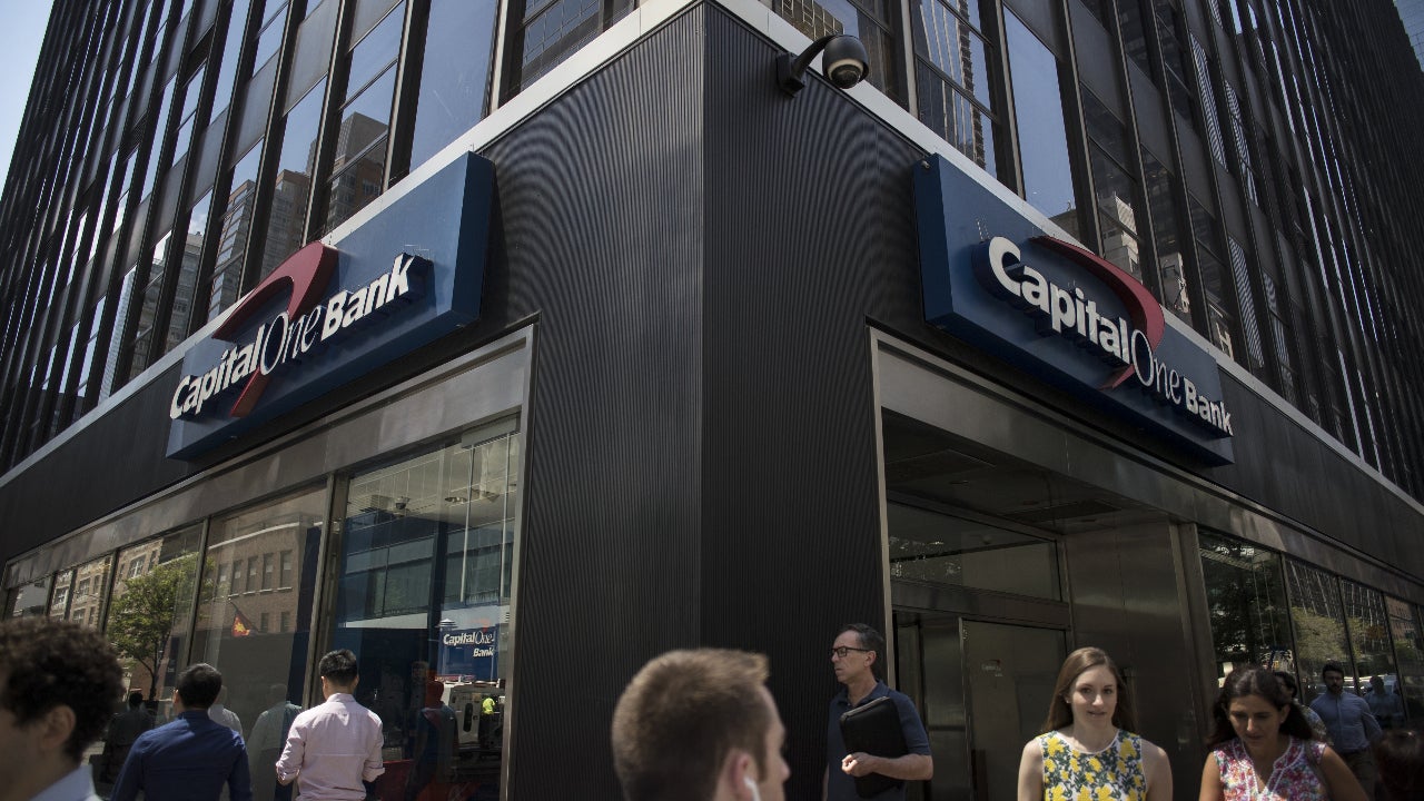 Pedestrians pass in front of a Capital One Financial Corp. bank branch in New York, U.S., on Wednesday, July 19, 2018. Capital One Financial Corp.