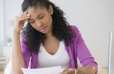 Mixed race woman paying bills online
