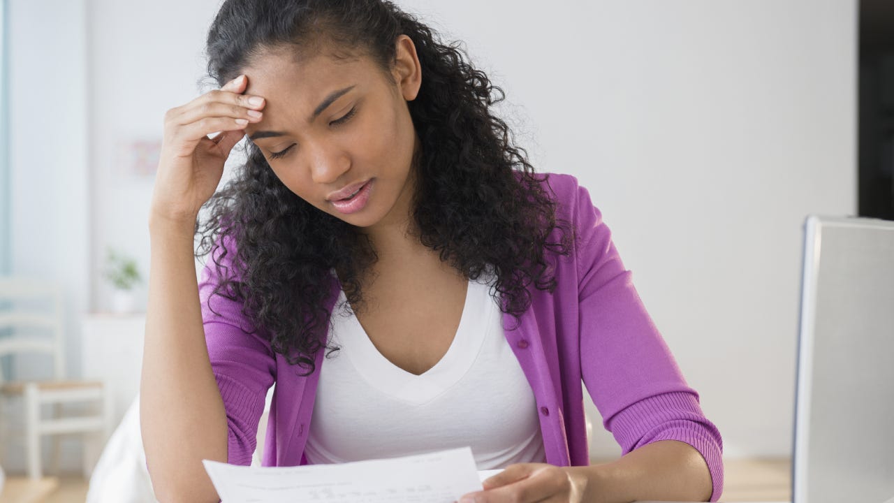 Mixed race woman paying bills online