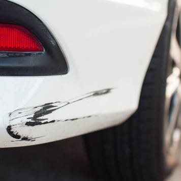 Rear car bumper with damaged paint