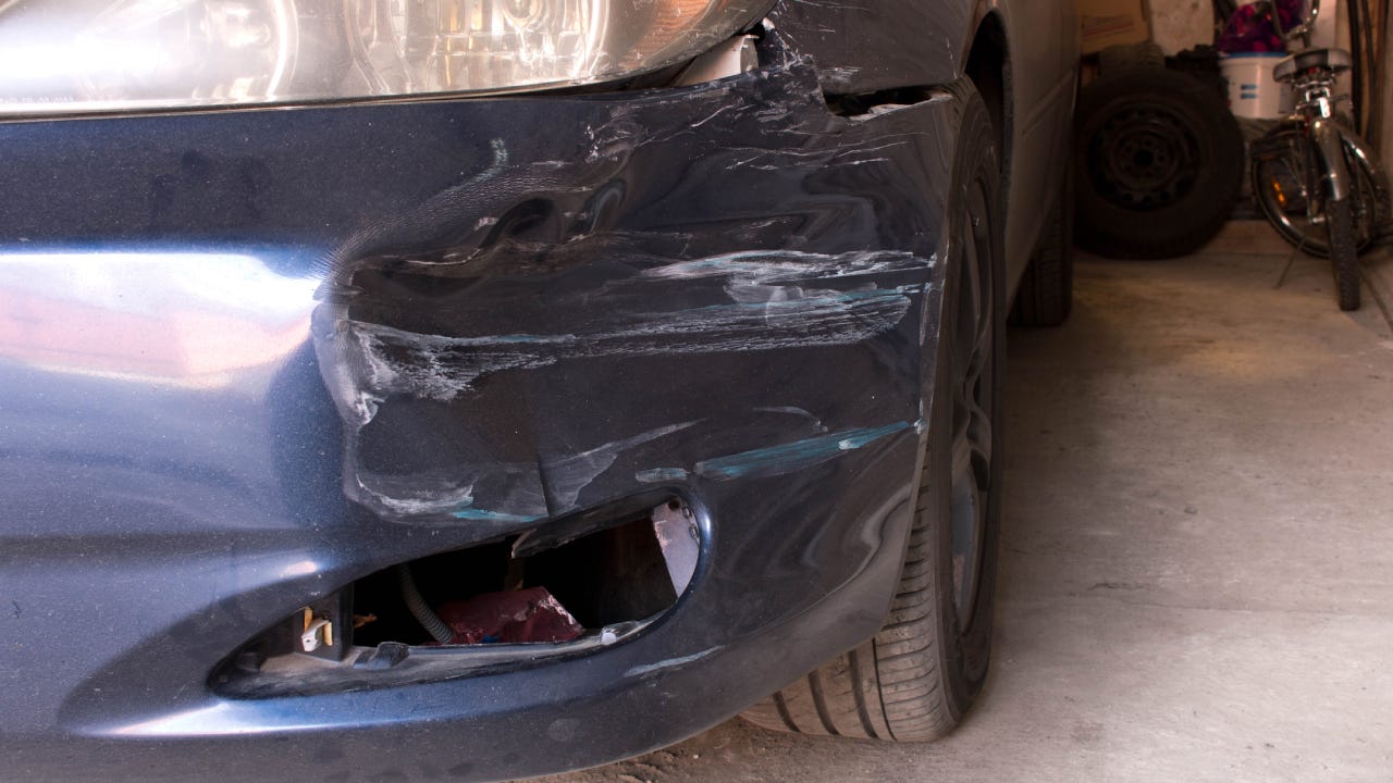 Damaged car. Broken front bumper. The concept of road safety.