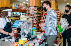 Supermarket staff work at a grocery store in medical protective mask