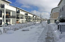 A snowy, modern apartment complex