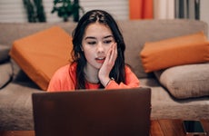 Young woman looks at a laptop