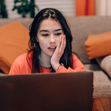 Young woman looks at a laptop