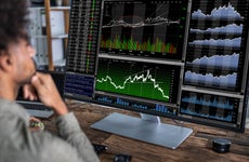 a trader looks at a stock chart on his computer