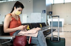 Woman sitting in airport with her luggage