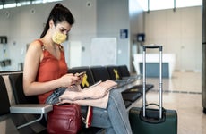 Woman sitting in airport with her luggage