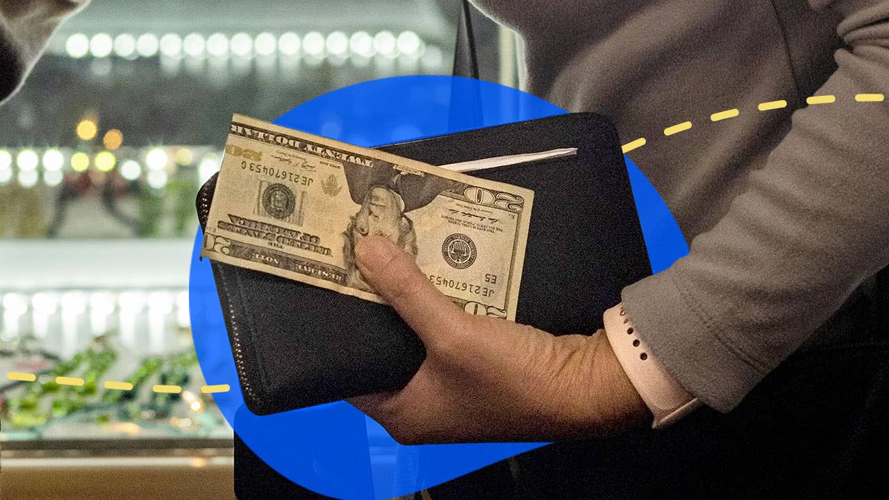 woman holding wallet with twenty dollar bill