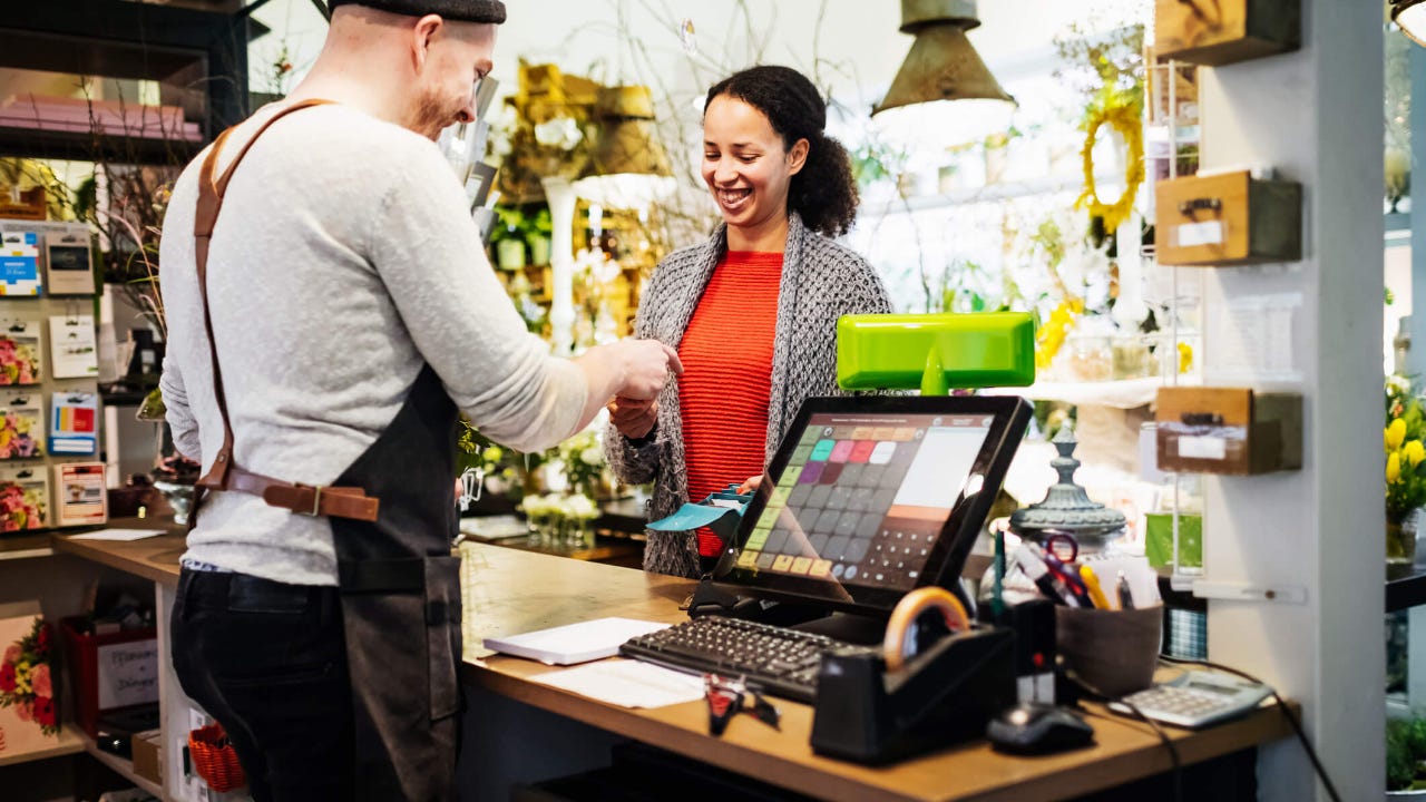 Smiling woman paying with her credit card in a store