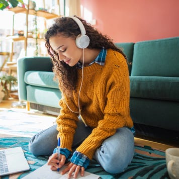 Student using laptop in a living room