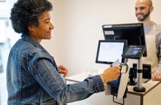woman using tap to pay at a store