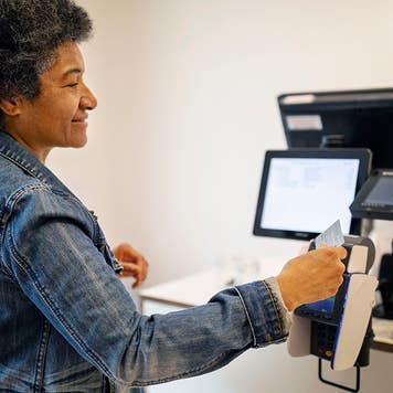 woman using tap to pay at a store