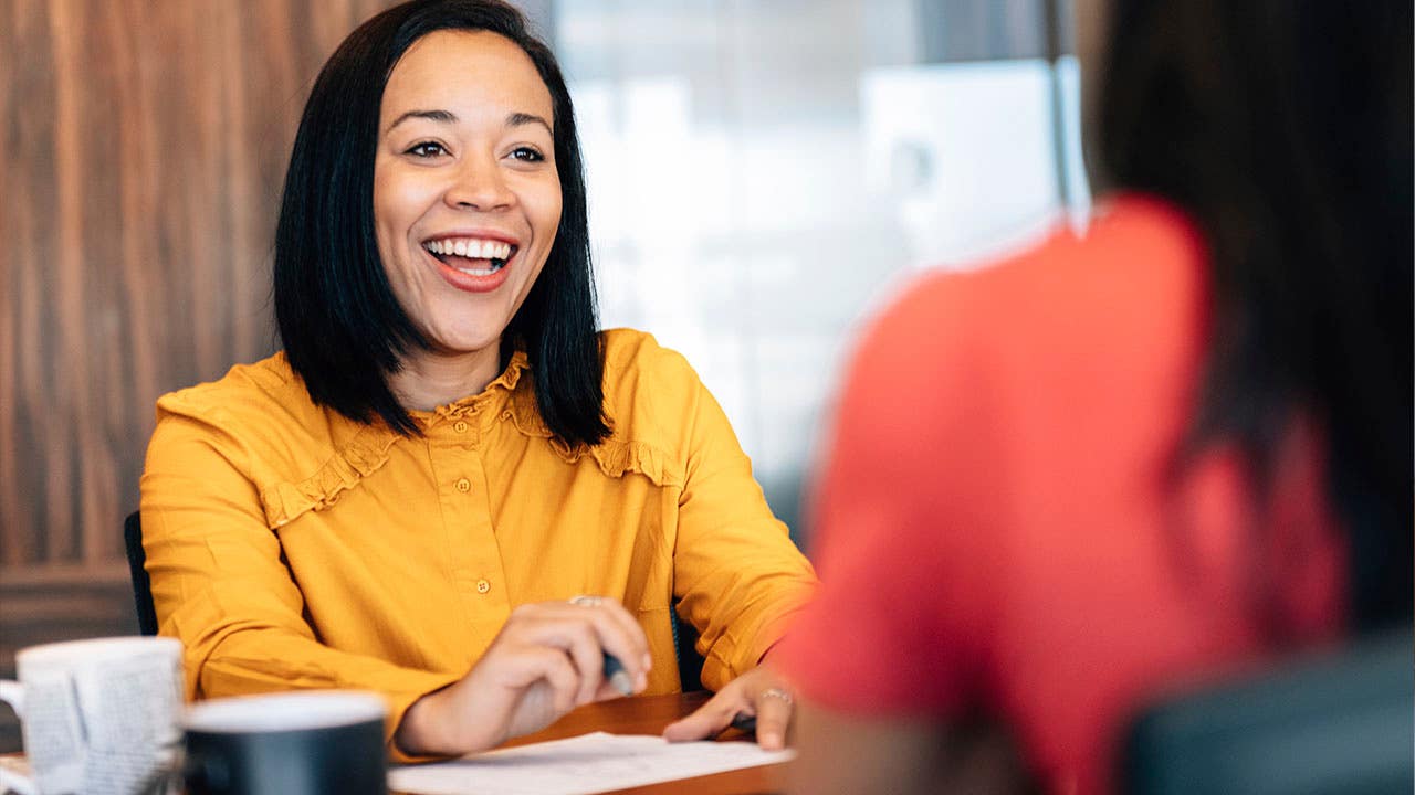 a woman at a bank signing papers