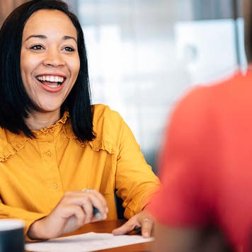 a woman at a bank signing papers