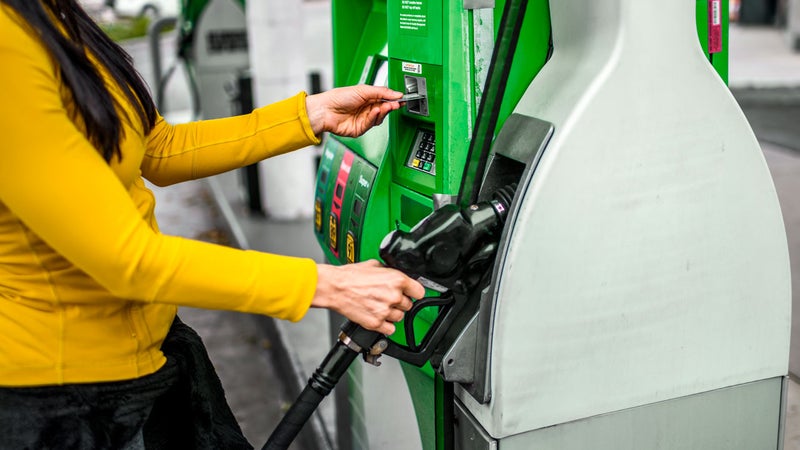woman purchasing gas at pump