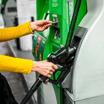 woman purchasing gas at pump
