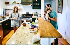 family making breakfast in home kitchen