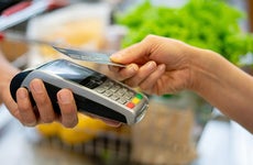 person paying for groceries with a credit card