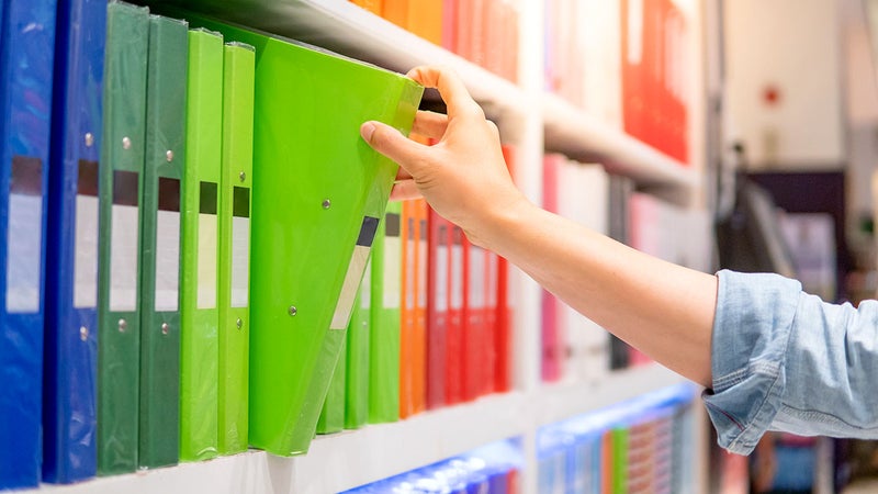a person picking out file folders at an office supply store
