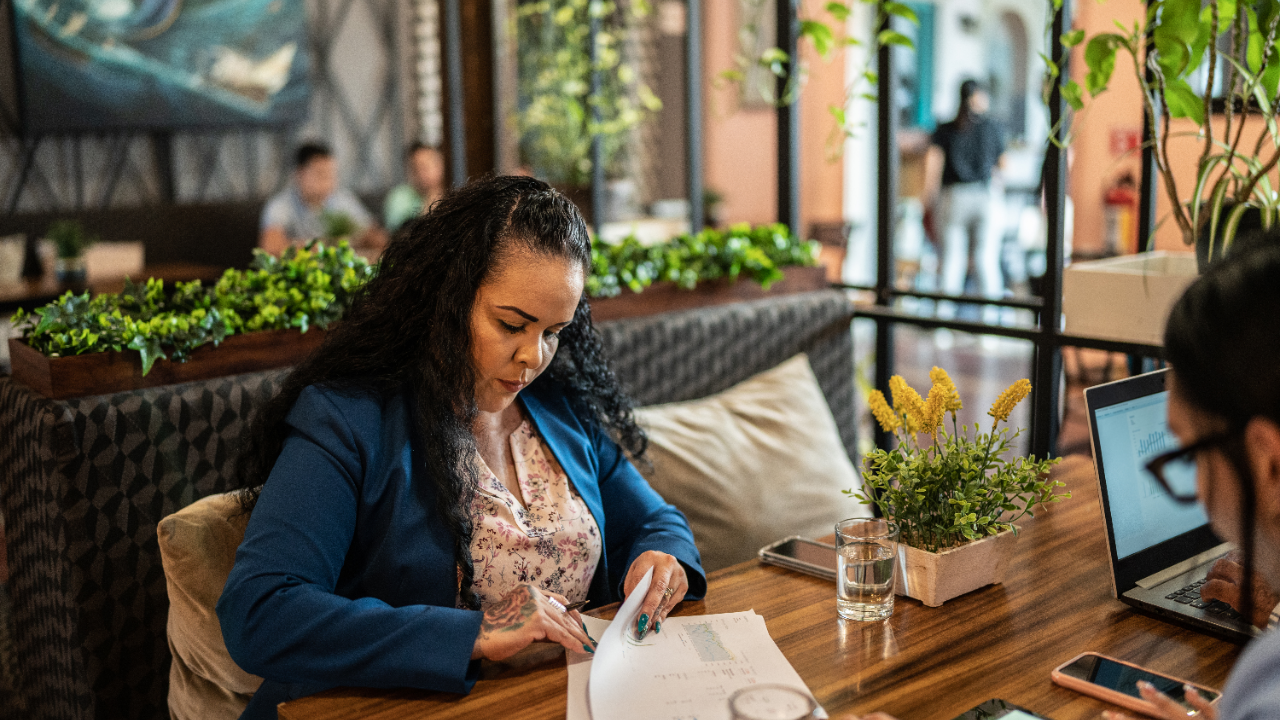 a women at a table sorting through papers